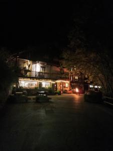 a dark street at night with a house with lights at Agriturismo La Gerla in Cesana Torinese +5 photos