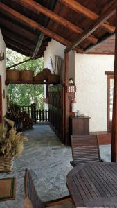 a patio with a table and chairs in a building at Agriturismo La Gerla in Cesana Torinese