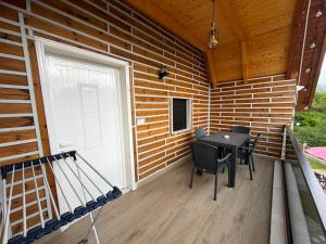 a porch of a house with a table and chairs at Villa Bushati in Tropojë