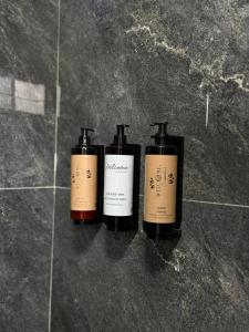 a trio of three bottles sitting on a floor at Villa Bushati in Tropojë