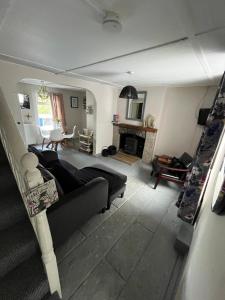 a living room with a couch and a fireplace at Hallow Cottage in Newtownstewart