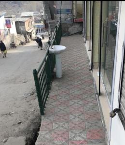 a sink on a sidewalk next to a street at Ibrahim lodge restaurant in Astor +2 photos