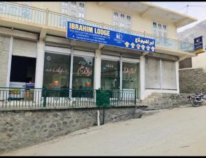 a building with a blue sign on top of it at Ibrahim lodge restaurant in Astor