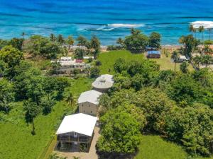 an aerial view of a house with the ocean in the background at Tres Amigos Beach House, Rincon PR in Rincon