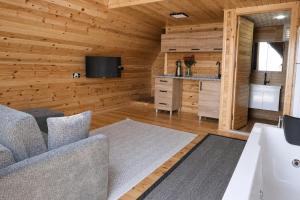 a living room with wooden walls and a tv and a couch at Iotape Hotel Antalya in Işıklı