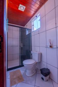 a white bathroom with a toilet and a shower at BLUE DOOR BRASIL in Abraão +31 photos