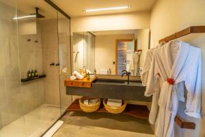a bathroom with a shower and a sink and a mirror at NANNAI Milagres in São Miguel dos Milagres +12 photos