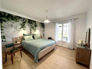 a bedroom with a large bed and a window at Petit gîte du nouguès in Garrey