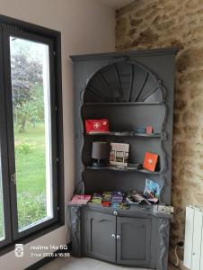a shelf in a room next to a window at La Cadournaise in Saint-Seurin-de-Cadourne