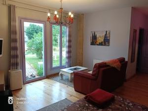 a living room with a couch and a window at La Cadournaise in Saint-Seurin-de-Cadourne