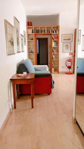 a bedroom with a bed and a table and shelves at La casa di Lori in San Benedetto del Tronto