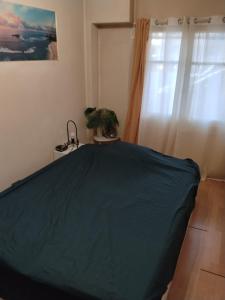 a bedroom with a bed with a blue blanket at Le rdv incontournable in Nancy