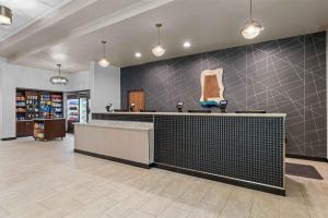 a lobby of a store with a counter and lights at Drury Plaza Hotel Mobile in Mobile +32 photos