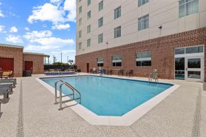 a large swimming pool in front of a building at Drury Plaza Hotel Mobile in Mobile