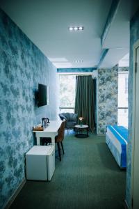 a hotel room with a bed and a desk at Avenue Nizami hotel in Baku