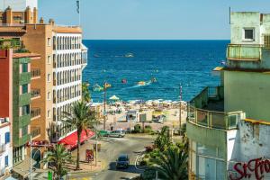 a view of a beach with buildings and the ocean at Marina Beach Apartaments - Sea views in the heart of Lloret in Lloret de Mar