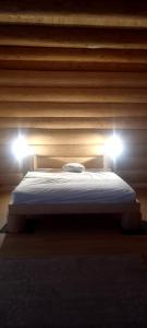 a bed in a room with two lights on it at Rönk Villa Demjèn in Demjén