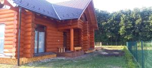 a log cabin with a solar roof on it at Rönk Villa Demjèn in Demjén