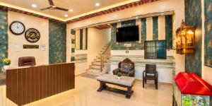a lobby with a waiting room with a tv and a table at Shree Ram Mandir 500m Walk - Atharav Palace in Ayodhya