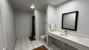 a white bathroom with a sink and a toilet at Studio 6 Suites Urbana, IL in Urbana +25 photos
