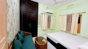 a bedroom with a bed and a couch in a room at R S Homestay in Deoghar