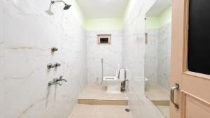 a bathroom with a toilet and a shower at R S Homestay in Deoghar