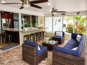 a living room with blue couches and a bar at Tropical Oasis 10th in Bradenton