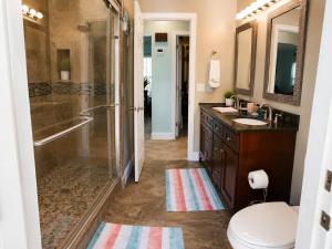 a bathroom with a shower and a toilet and a sink at Tropical Oasis 10th in Bradenton +19 photos