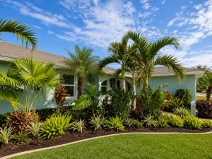 a house with palm trees in the front yard at Tropical Oasis 10th in Bradenton