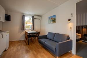 a living room with a couch and a table at Hotel Balka Strand in Neksø