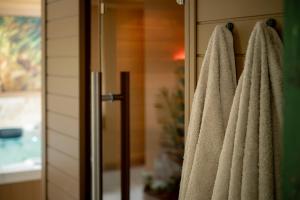 a bathroom with towels hanging on a door at Maison Bienvenue in Lierop