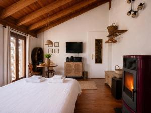 a bedroom with a large white bed in a room at Ca' Bastiàn in Sacco