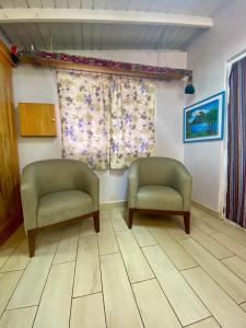 two chairs in a waiting room with a window at Lake Front Retreat at Los Elementos in Santa Cruz La Laguna
