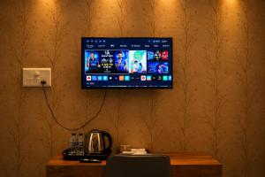 a flat screen tv hanging on a wall at Hotel Prince Paradise in Patna