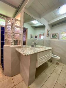 a bathroom with a sink and a toilet at Lake Front Retreat at Los Elementos in Santa Cruz La Laguna +51 photos