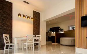 a kitchen and dining room with a table and chairs at Sweethome12 in Fonyód