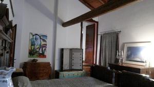 a living room with a bed and a television at Agriturismo la Torre in Argelato