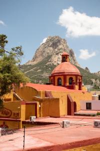 a church with a mountain in the background at Hotel Villa Bernal in Bernal