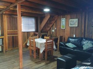a living room with a table and a couch at Casa do Campo in Ilha do Mel