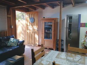 a living room with a couch and a table at Casa do Campo in Ilha do Mel