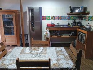 a kitchen with a table and a kitchen with a sink at Casa do Campo in Ilha do Mel +14 photos