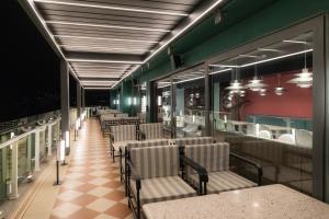 a row of chairs and tables in a restaurant at Proza Hotel & Restaurant in Kutaisi
