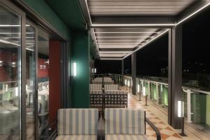 a dining room with chairs and green walls at Proza Hotel & Restaurant in Kutaisi