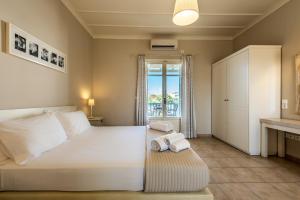 a bedroom with a bed with towels on it at Almyris in Adamantas