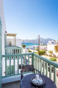 a table on a balcony with a view of the ocean at Almyris in Adamantas