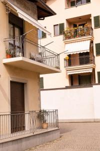 an apartment building with balconies and flowers at Savian Apartment in Savigliano