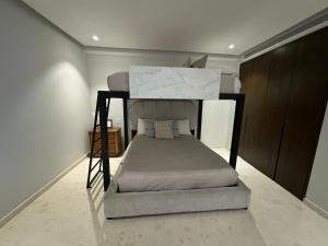 a bedroom with a bunk bed in a room at Departamento Pacific Luxury Punta Mita, Beachfront in Higuera Blanca +27 photos