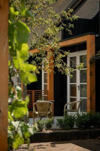 a patio with a table and chairs in front of a house at Maison Bienvenue in Lierop