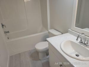 a white bathroom with a toilet and a sink at Private 2 bedroom suite close to everything! in Maple Ridge +16 photos