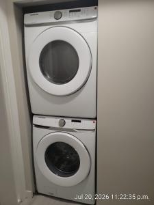 a washing machine and a washer and dryer at Private 2 bedroom suite close to everything! in Maple Ridge